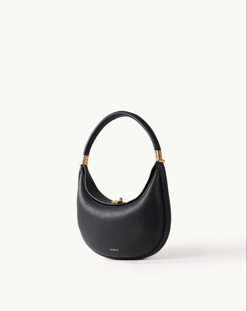 Songmont Luna Bag Black Leather (Category: Shoulder Bags) located in Singapore. Submitted by hello.goodbuy (Listing ID 1456418817, Image 1). Description: Songmont Luna bag. Used but as good as new, well kept. Comes with dust bag and extra strap (for crossbody). Condition: 7.5/10 Meetups at specified location only (no MRT stations) - Brand: Songmont - Color: Black - Material: Leather - Shape: Crescent moon - Hardware: Gold - Occasion: Daily use or