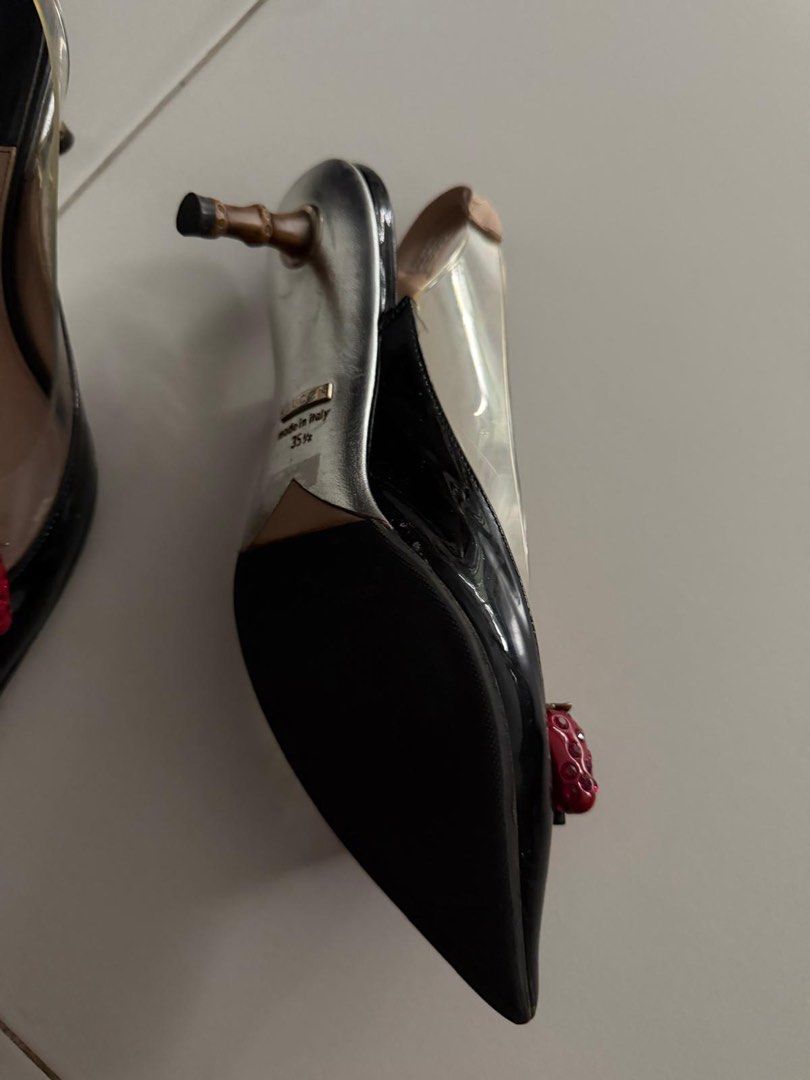 Gucci Slingback Heels with Strawberry Detail (Category: Heels) located in Singapore. Submitted by cheminologist (Listing ID 1456954955, Image 3). Description: - Gucci slingback heels - Black patent leather with clear PVC sides - Adorable strawberry charm with crystal accents at the toe - Moderate heel height - Made in Italy - Size: 35 1/2 Price negotiable. Pick up only..