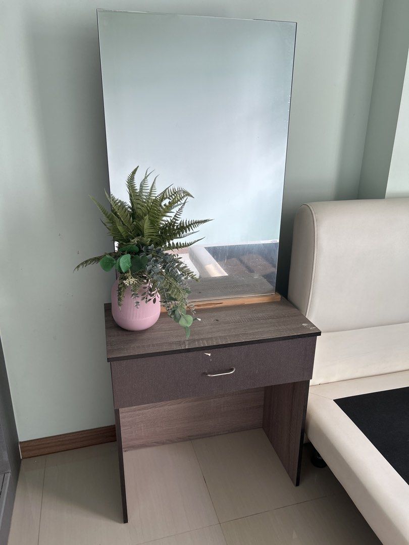 Compact Dressing Table with Mirror and Drawer (Category: Tables & Sets) located in Singapore. Submitted by yagaosingapore (Listing ID 1457984879, Image 1). Description: - Simple dressing table with integrated mirror - Features one convenient storage drawer - Elegant wood grain finish - Compact design ideal for smaller rooms - Easy assembly process - Versatile use: makeup vanity or side table - Sold in its current condition (as is).