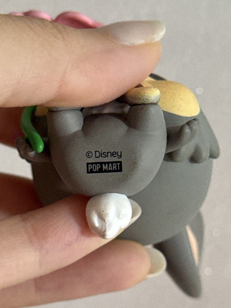 Disney POP MART Thump Blind Box Figure (Category: Designer & Blind Box Toys) located in Singapore. Submitted by grasshopper_moving (Listing ID 1458002162, Image 2). Description: - Adorable Disney x POP MART Thump figure. - Features a pink flower in hand and a blue flower on its head. - Authentic.