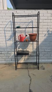 Black Metal Plant Stand with Pots, Watering Can, and Seedling Tray