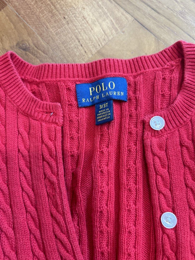 Polo Ralph Lauren Red Cable Knit Cardigan 3/3T (Category: Babies & Kids Fashion) located in Singapore. Submitted by decluttering_____ (Listing ID 1458186816, Image 2). Description: - Cute red cable knit cardigan - Brand: Polo Ralph Lauren - Features classic pony logo embroidered on chest - Button front closure - Perfect for layering - Size: 3/3T - Hardly worn - Self collect or top up $3 for tracked mail.