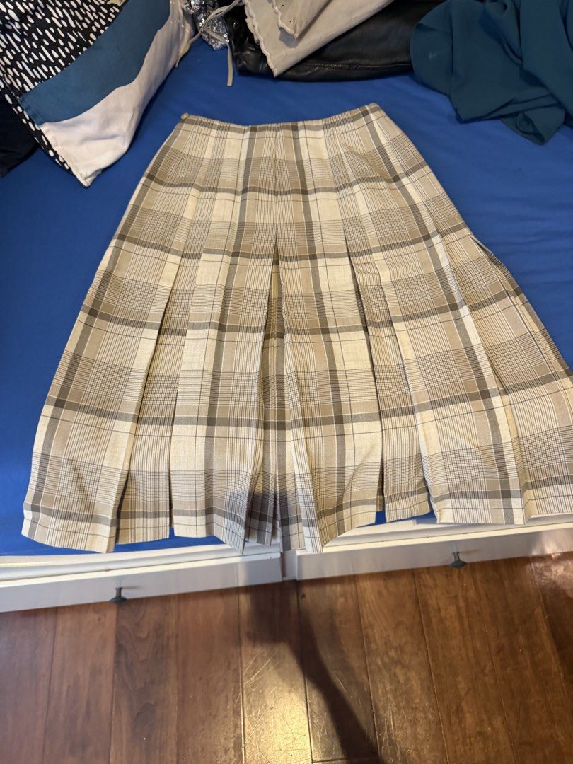 Fletcher Jones Australia Plaid Pleated Midi Skirt (Category: Skirts) located in Singapore. Submitted by leannavdk123 (Listing ID 1458573042, Image 1). Description: - Vintage Fletcher Jones skirt - Classic plaid pattern (beige & brown) - Pleated design - Midi length - Material: Polyester, Linen, Wool blend - Perfect for a retro aesthetic - Refer to tag for care instructions.