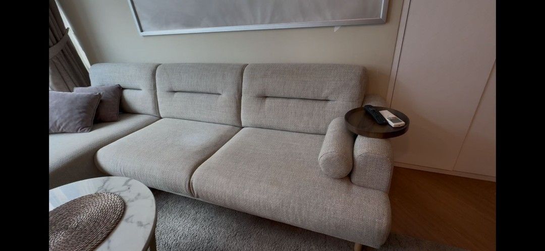 Light Grey Sectional Sofa with Pillows. NO TEAR. NO DAMAGE. Only some stains on the fabric. Used for around 6months only. Bought new for $1999. Now selling for $599. (Category: Sofas) located in Singapore. Submitted by letusbehappy (Listing ID 1458514615, Image 3). Description: - Light grey modern sectional sofa - Clean lines design - Comes with multiple throw pillows (grey & beige shades) - Small side table attachment on armrest - Minor stain on