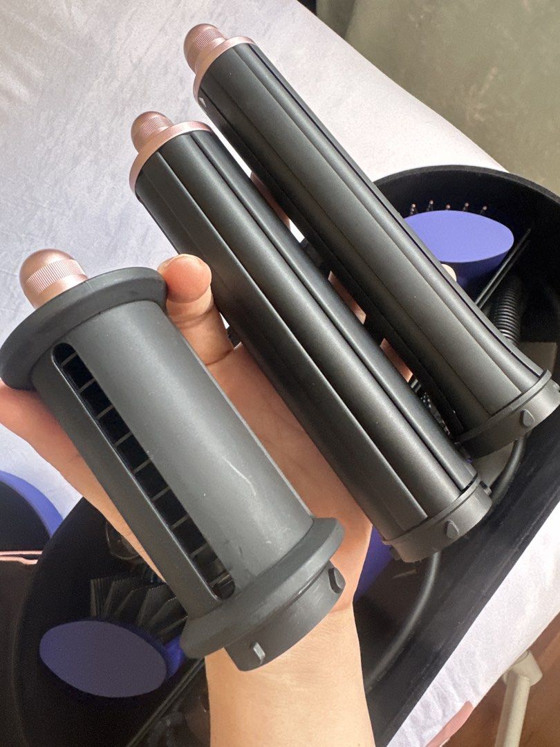 Dyson Airwrap Complete Styler - Purple (Category: Hair) located in Singapore. Submitted by wosieuh (Listing ID 1458783911, Image 4). Description: As good as new!!! - Dyson Airwrap Complete Styler in Purple - Includes main unit and all original barrels and brush attachments - Comes with original storage case - Includes black velvet wrap for protection - All items neatly organized in the case - Perfect for versatile hair styling Literally used twic
