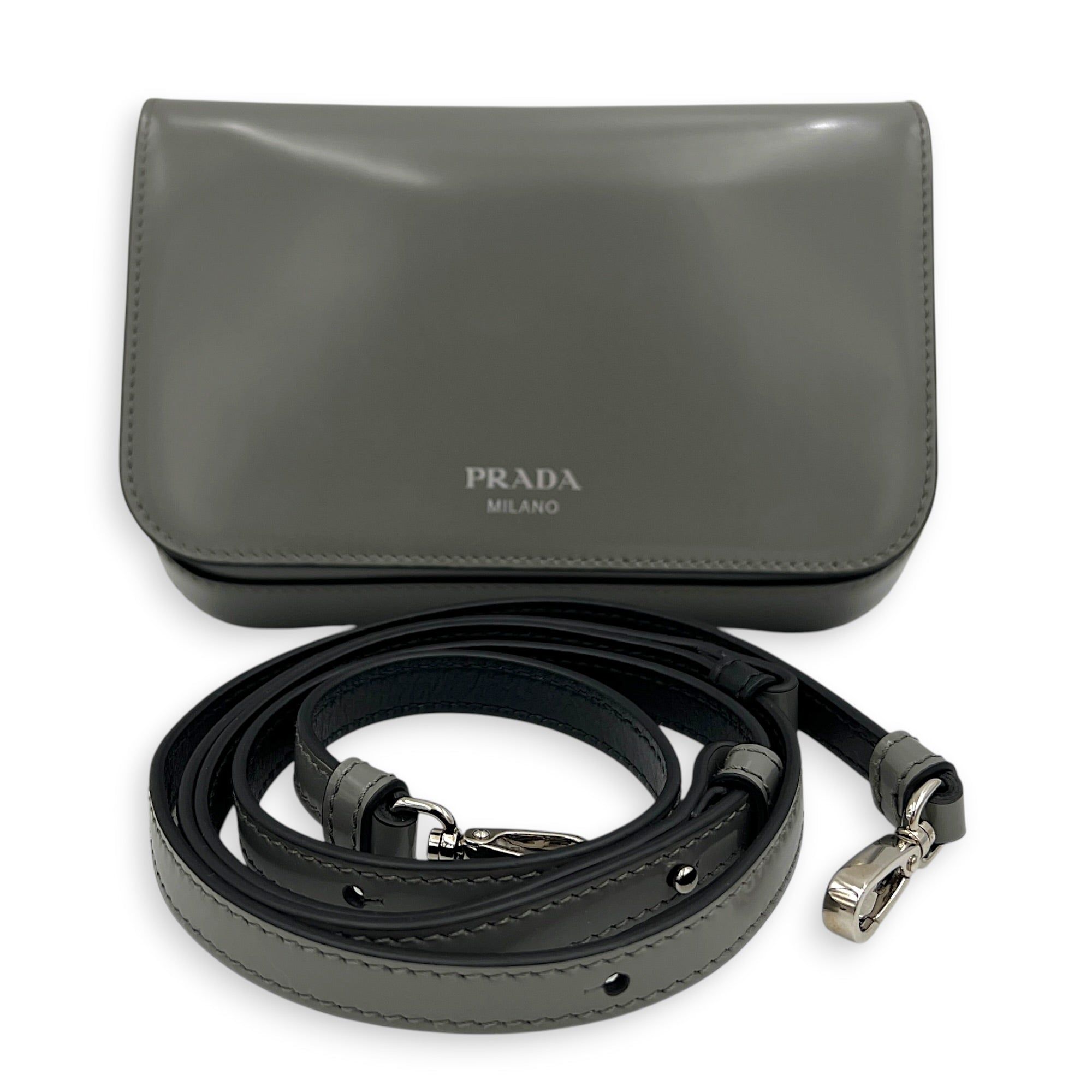 Prada Logo Crossbody Bag Grey in Patent Leather, Silver hardware (Category: Bags & Wallets) located in Singapore. Submitted by carousellluxury (Listing ID 1433497755, Image 10). Description: SKU C2604-011345AA Material Patent Leather Color Grey Hardware Silver Strap Included, detachable Dimension (L)18cm x (H)10cm x (W)7cm Accessories Dust Bag, Series 7/K Circa Est NA Microchipped FALSE Condition - Surface: In very good condition overall - Bottom