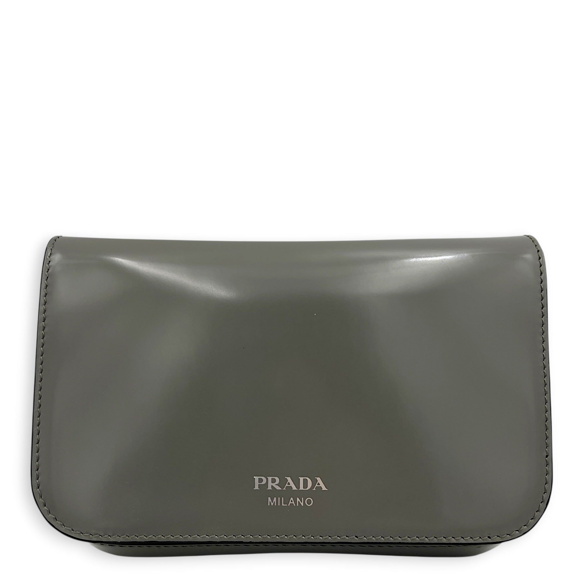 Prada Logo Crossbody Bag Grey in Patent Leather, Silver hardware (Category: Bags & Wallets) located in Singapore. Submitted by carousellluxury (Listing ID 1433497755, Image 1). Description: SKU C2604-011345AA Material Patent Leather Color Grey Hardware Silver Strap Included, detachable Dimension (L)18cm x (H)10cm x (W)7cm Accessories Dust Bag, Series 7/K Circa Est NA Microchipped FALSE Condition - Surface: In very good condition overall - Bottom 