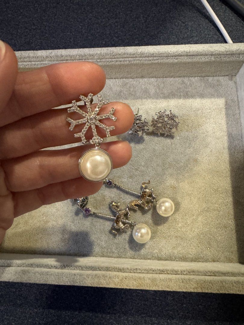 Snowflake and Carousel Horse Pearl Dangle Earrings Set (Category: Earrings) located in Singapore. Submitted by pppppppppq (Listing ID 1454594413, Image 2). Description: He fang earrings ( China Jewelry designer brand ) 1) pearl front is white back is light grey 2) snowflake 3) Carosell horse can move Price for each pair .